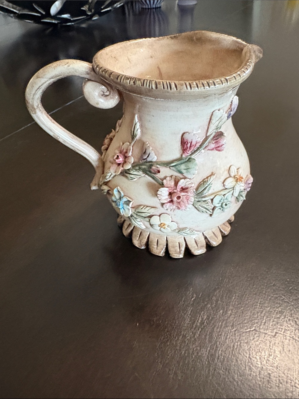 Capodimonte porcelain small pitcher, decorated with high-relief floral elements.
